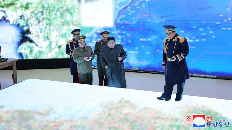 Kim Jong-un shows himself warlike as a strategist in front of an oversized map
